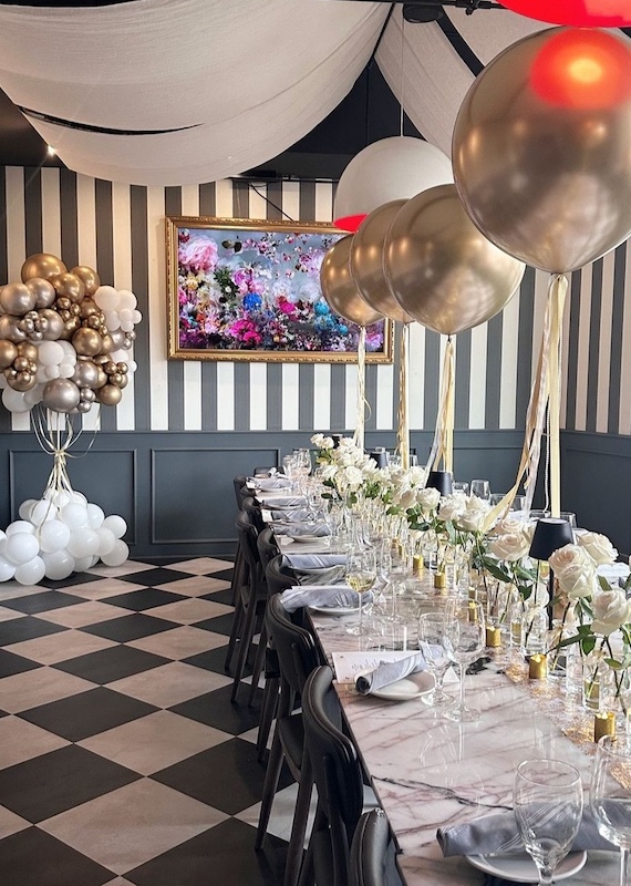 Private event at Vincenzo Cucina & Lounge with table set with balloons and florals